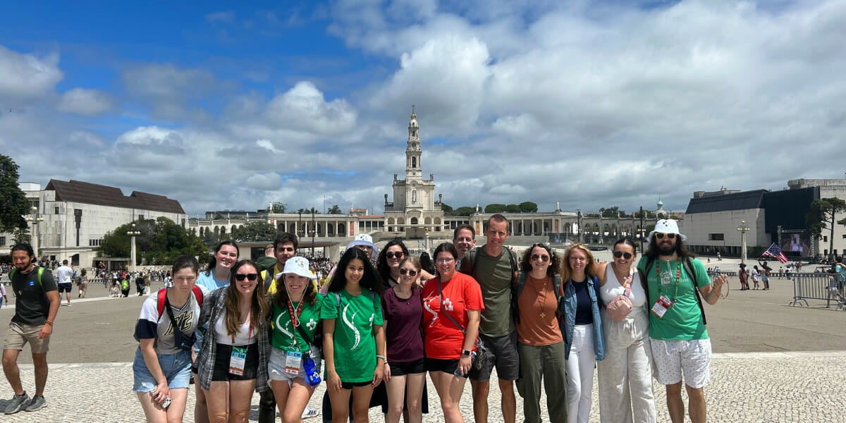A group of students in front of a church.